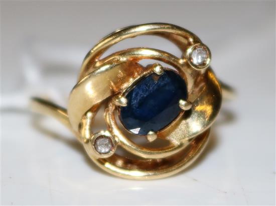 Sapphire and diamond ring in scrolled yellow metal setting